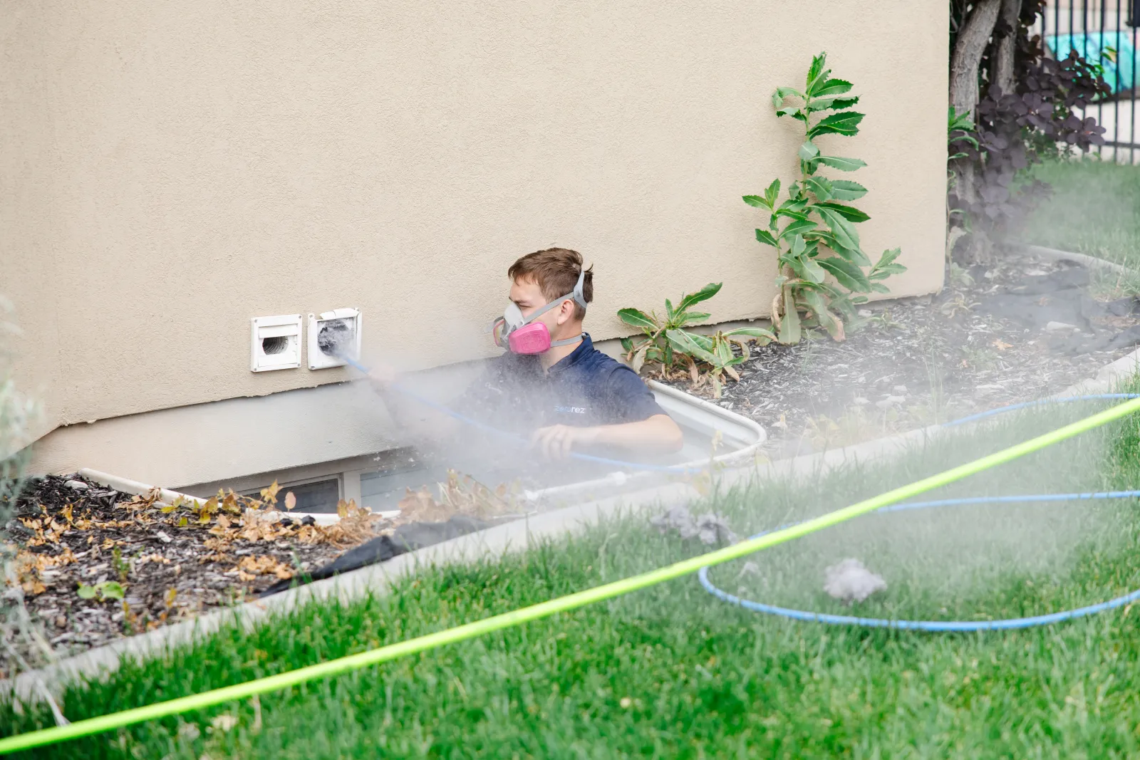 Zerorez technician with tools cleaning a dryer vent in a home